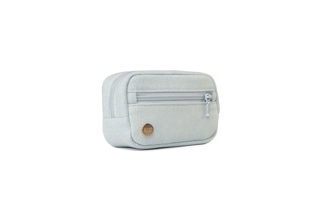 A light blue Dream Wash Denim accessory bag for Mabē slings and buckle carriers centered on a solid white background.